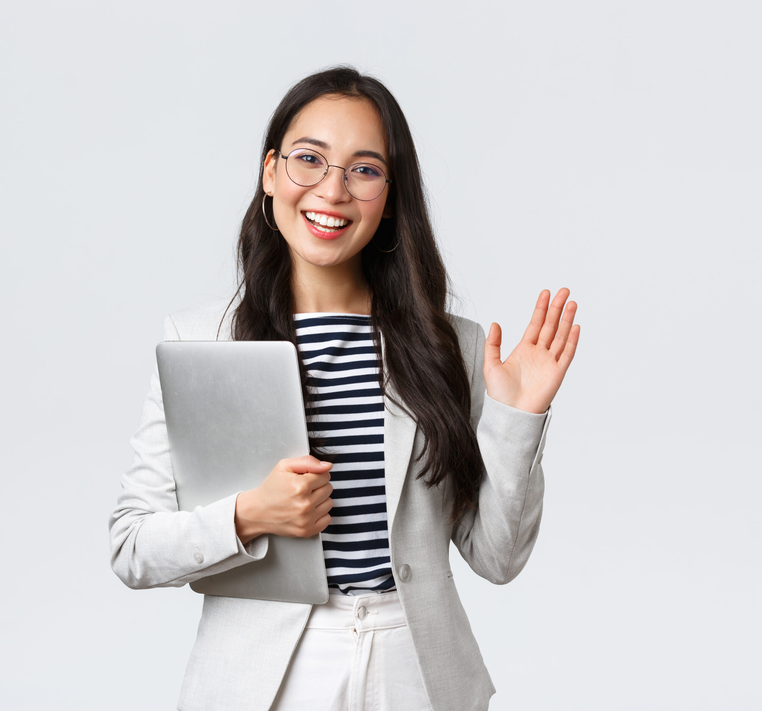 Business, finance and employment, female successful entrepreneurs concept. Friendly smiling office manager greeting new coworker. Businesswoman welcome clients with hand wave, hold laptop Business, finance and employment, female successful entrepreneurs concept. Friendly smiling office manager greeting new coworker. Businesswoman welcome clients with hand wave, hold laptop.